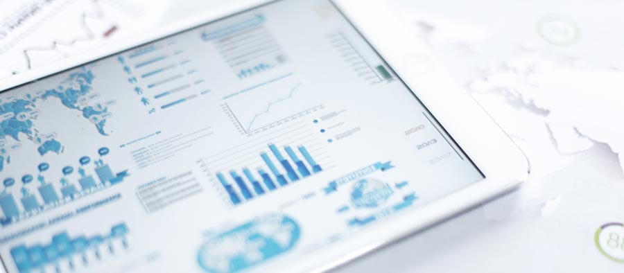 A closeup of a smart tablet displaying various charts, graphs, and data.