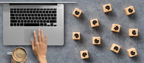 Dice with Cookie icons and a laptop conceptual of the GDPR regulations introduced by the EU governing data collection and privacy of information for individuals online