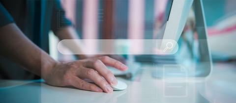 Businessman using computer mouse to search for information